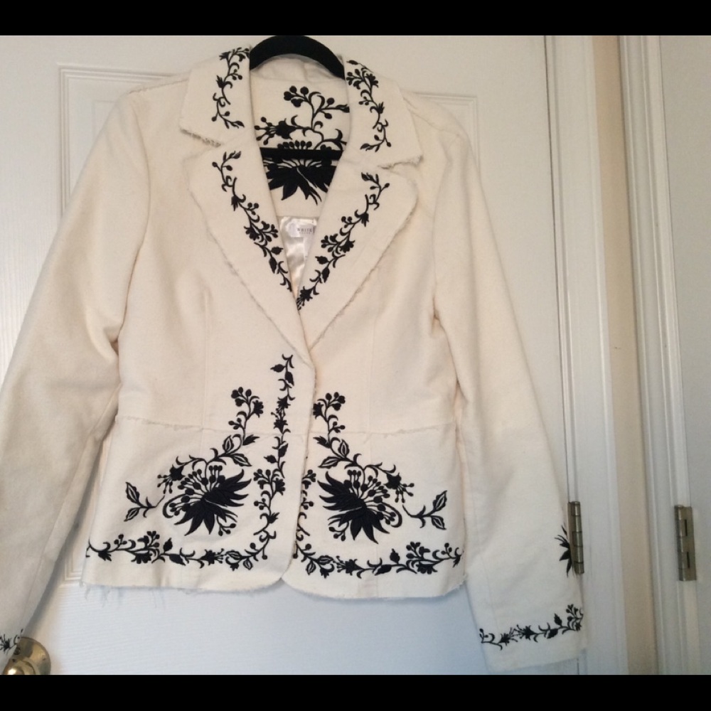 A white suit jacket with black flower designs